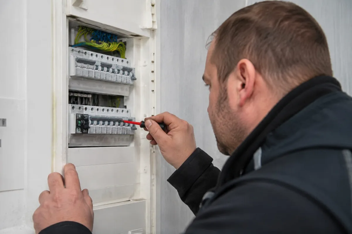 Elektriker prüft die Sicherungen im Verteilerkasten